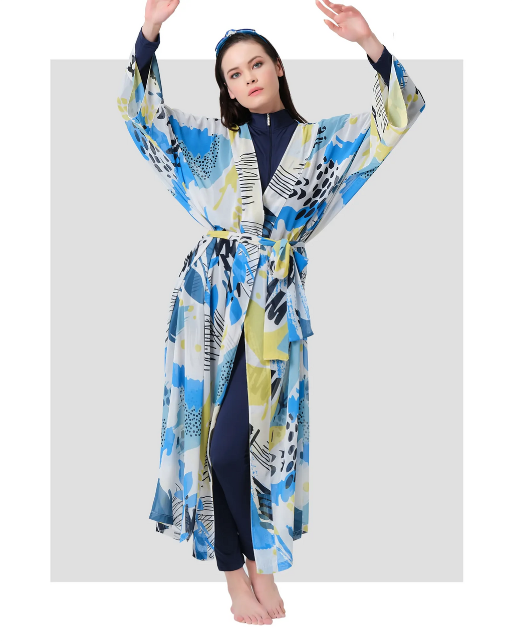 Woman in blue and yellow printed kimono swimwear, full front view.