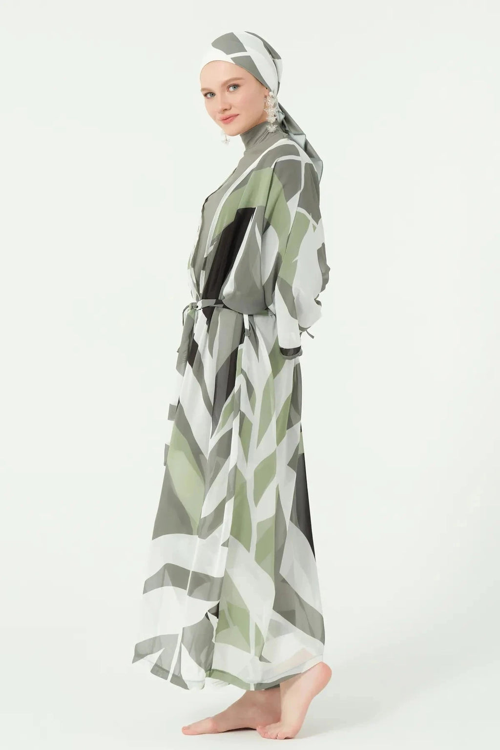 Side view of model in geometric print kimono with matching head covering.