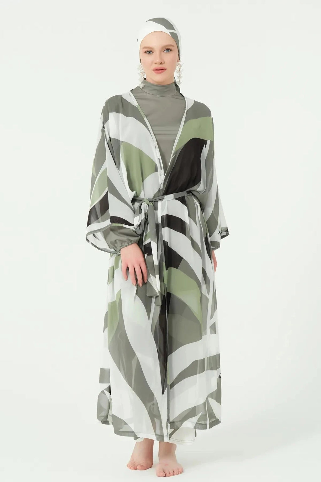 Front view of model in geometric print kimono with belt tied.