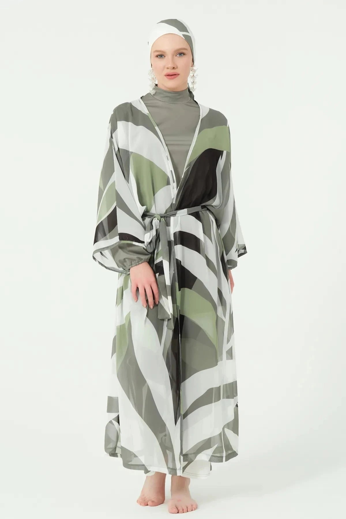 Front view of model in geometric print kimono with belt tied.