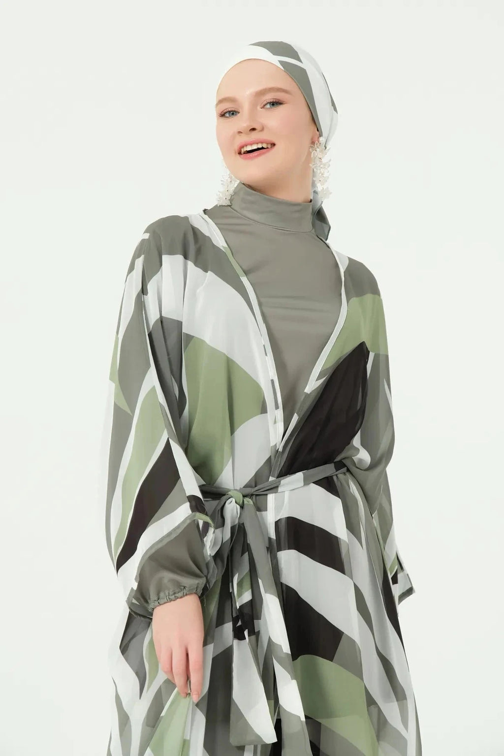 Close-up of model smiling, showing geometric print kimono and belt detail.
