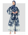 Woman in navy and white tropical print kimono with belt, front view.