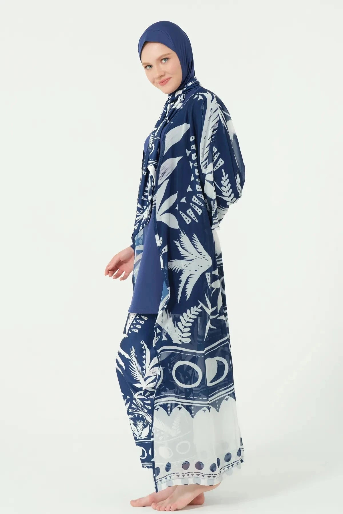 Woman in navy and white tropical print kimono, side profile.