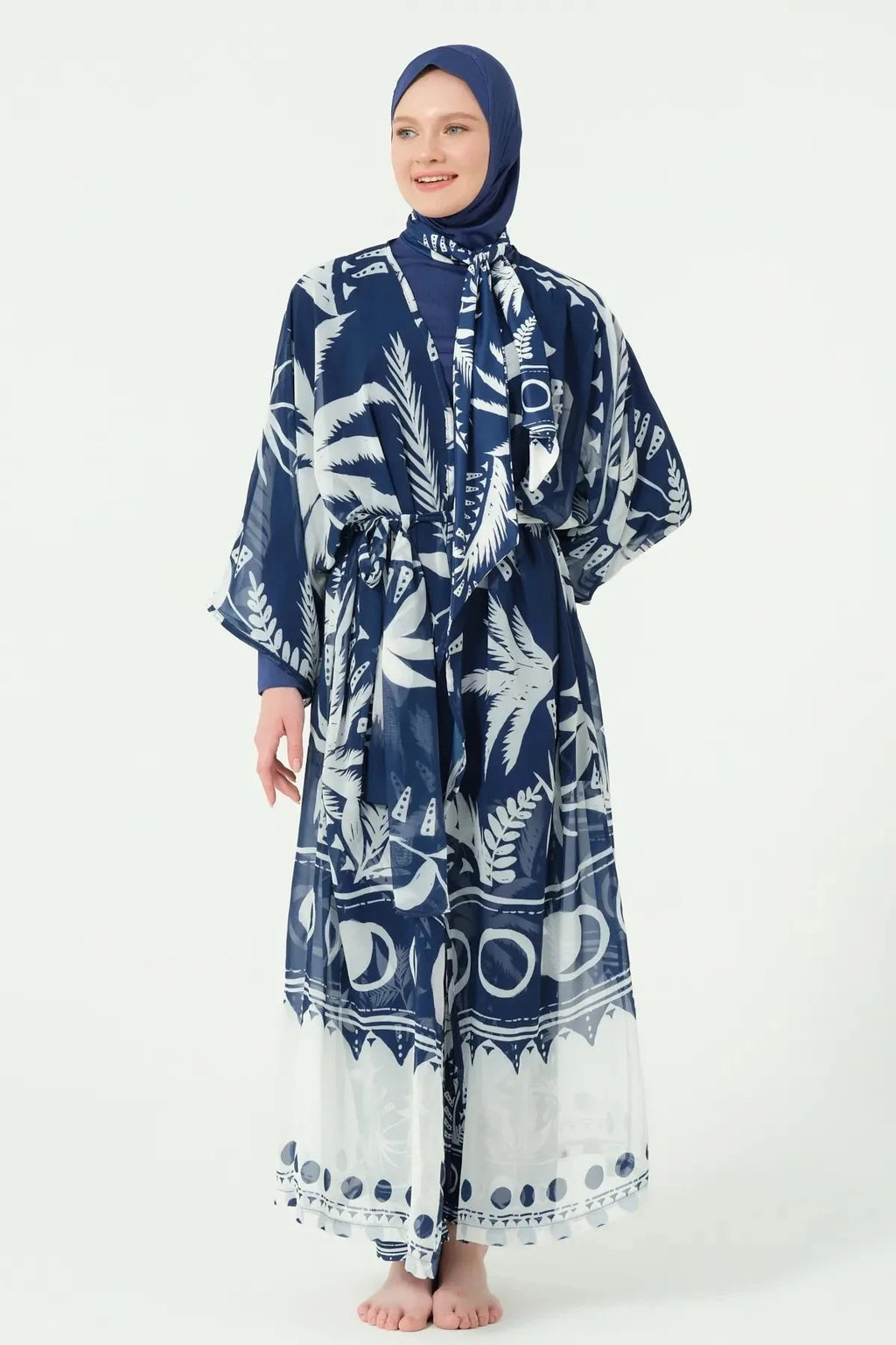 Woman in navy print kimono closed with belt, front view.