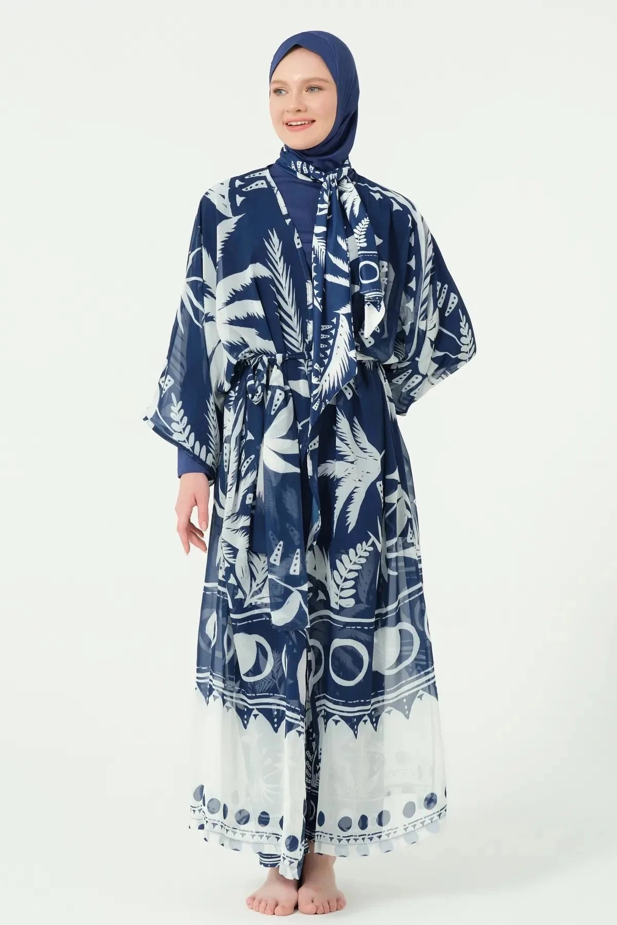 Woman in navy print kimono closed with belt, front view.