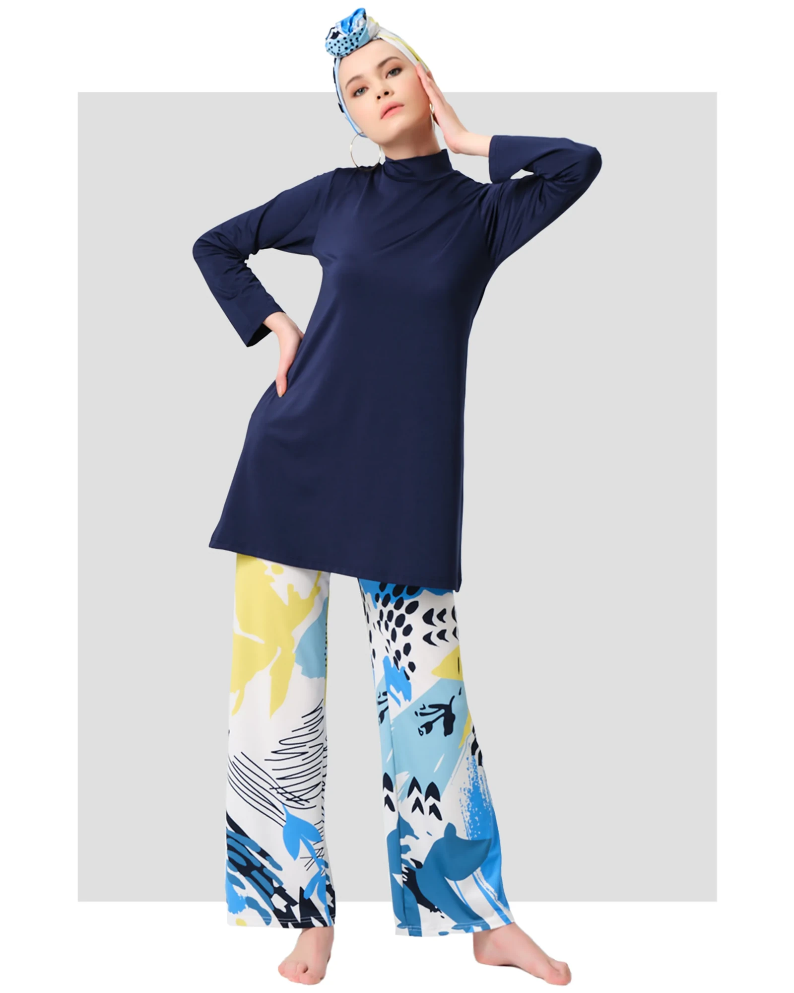 Model in navy modest swimwear set with abstract print pants, front view.