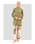 Model in olive green burkini set with botanical print pants, front view.