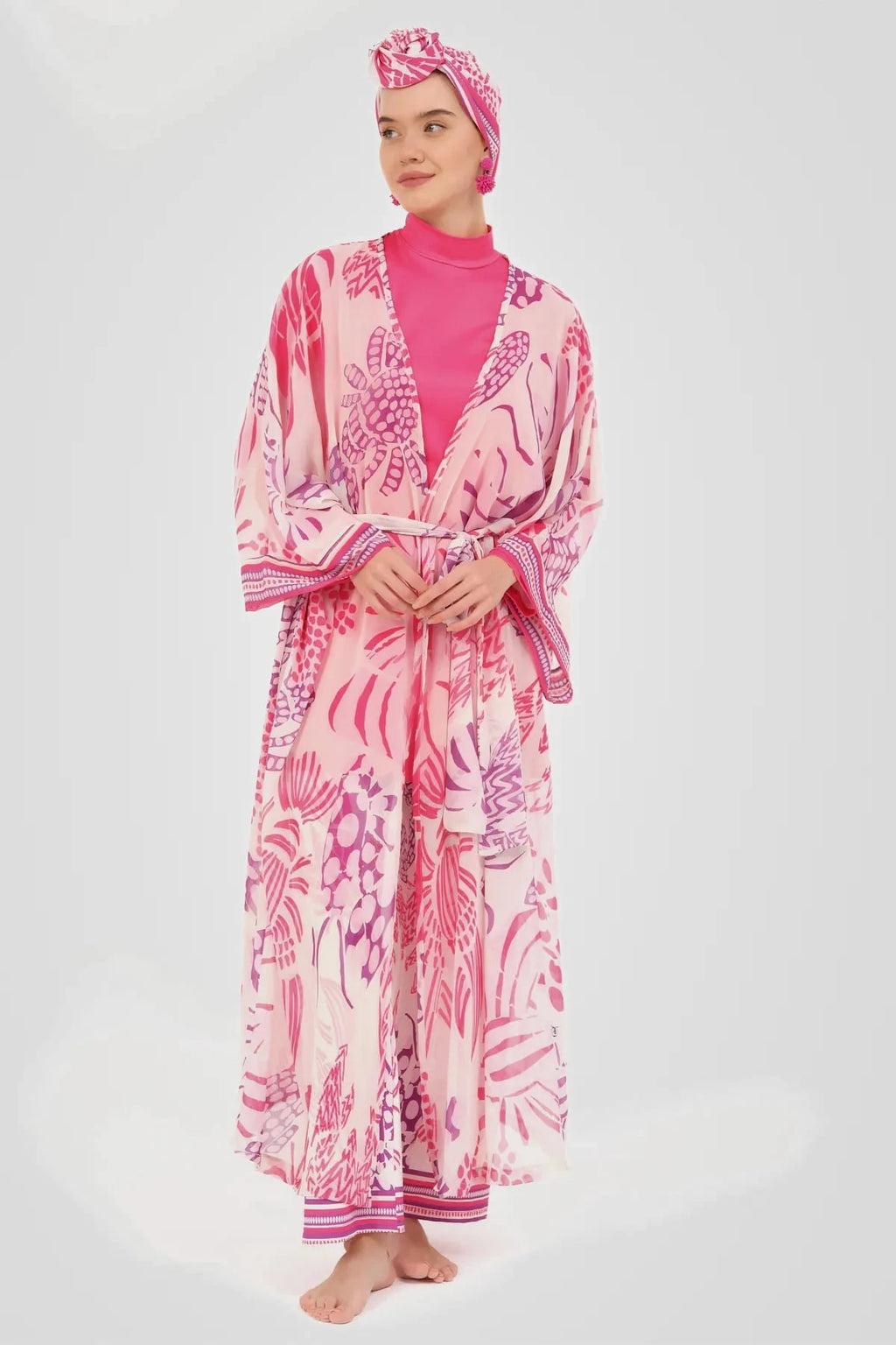 Model wearing pink floral sheer kimono with tie belt, front closed.