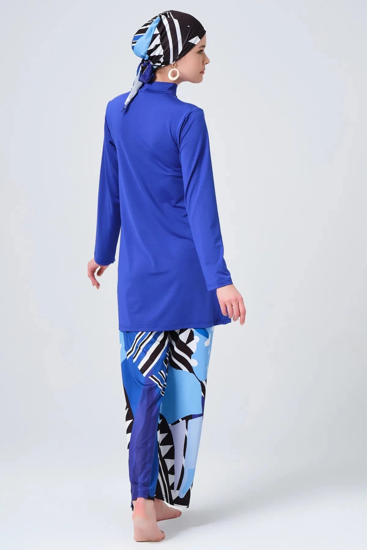 Sapphire blue modest burkini set back view with abstract print pants.