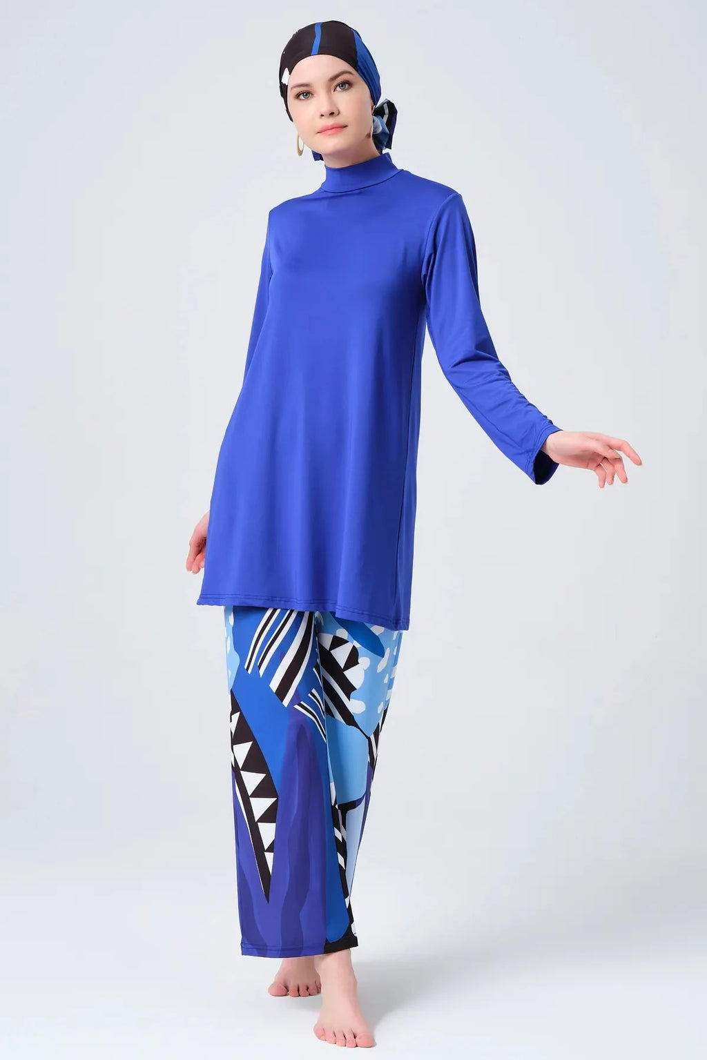Modest sapphire blue burkini set with abstract print pants in full pose.
