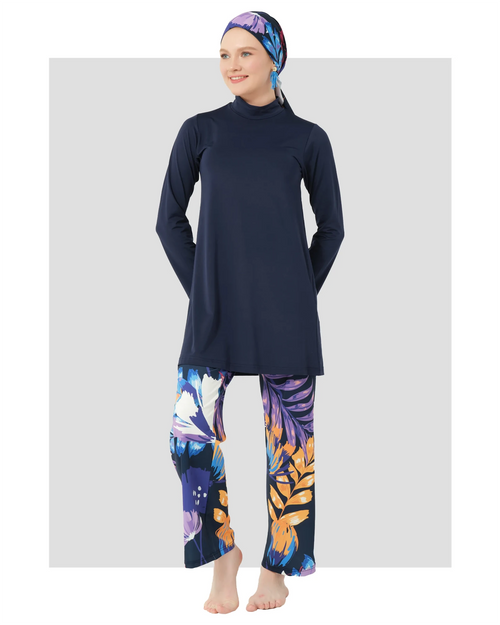 Woman in navy modest swimwear set with botanical print pants.