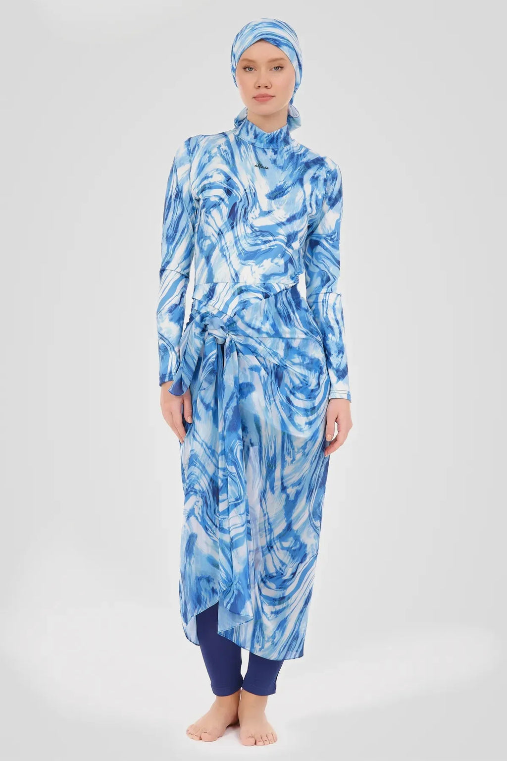 Woman in indigo ocean wave print modest sarong and swimwear set full view