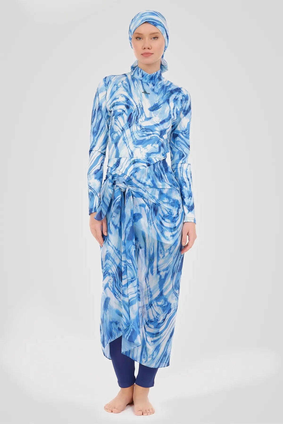 Woman in indigo ocean wave print modest sarong and swimwear set full view