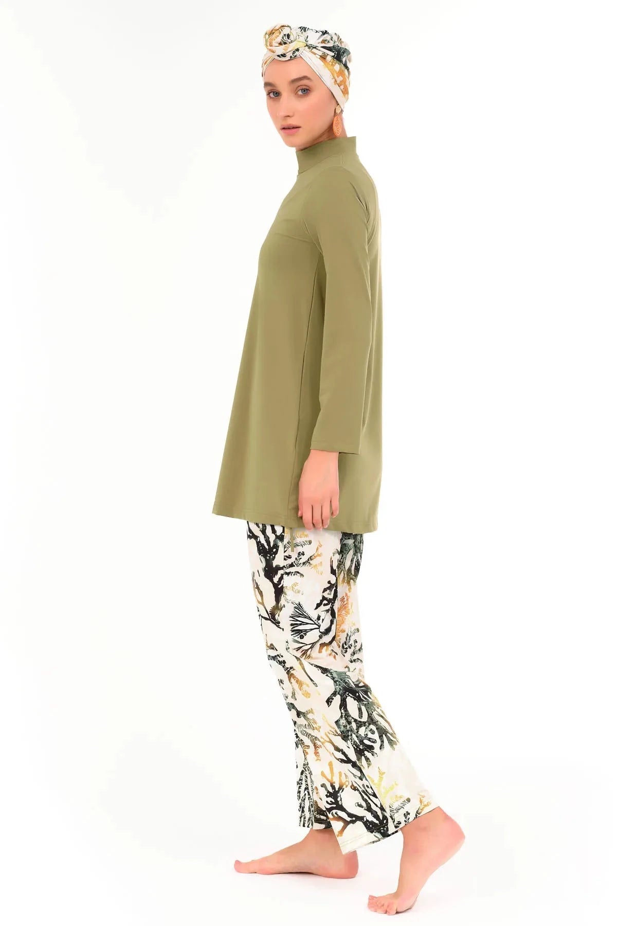 Model in golden olive modest swimwear set, side profile