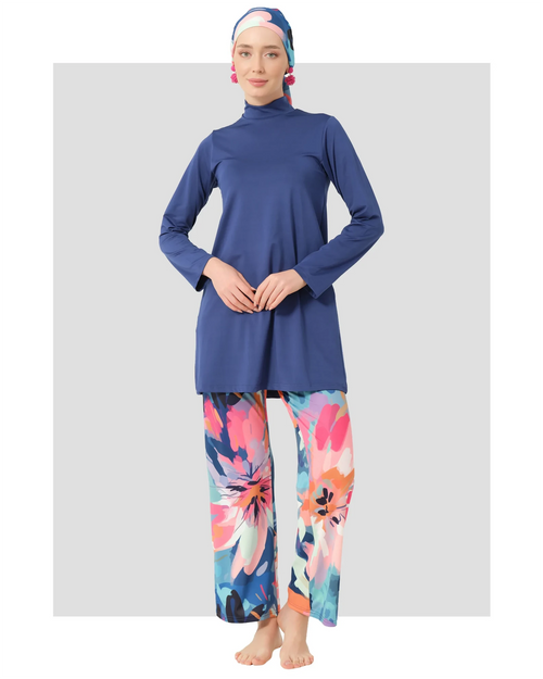 Woman in indigo floral modest swimwear set, front view, on white background.