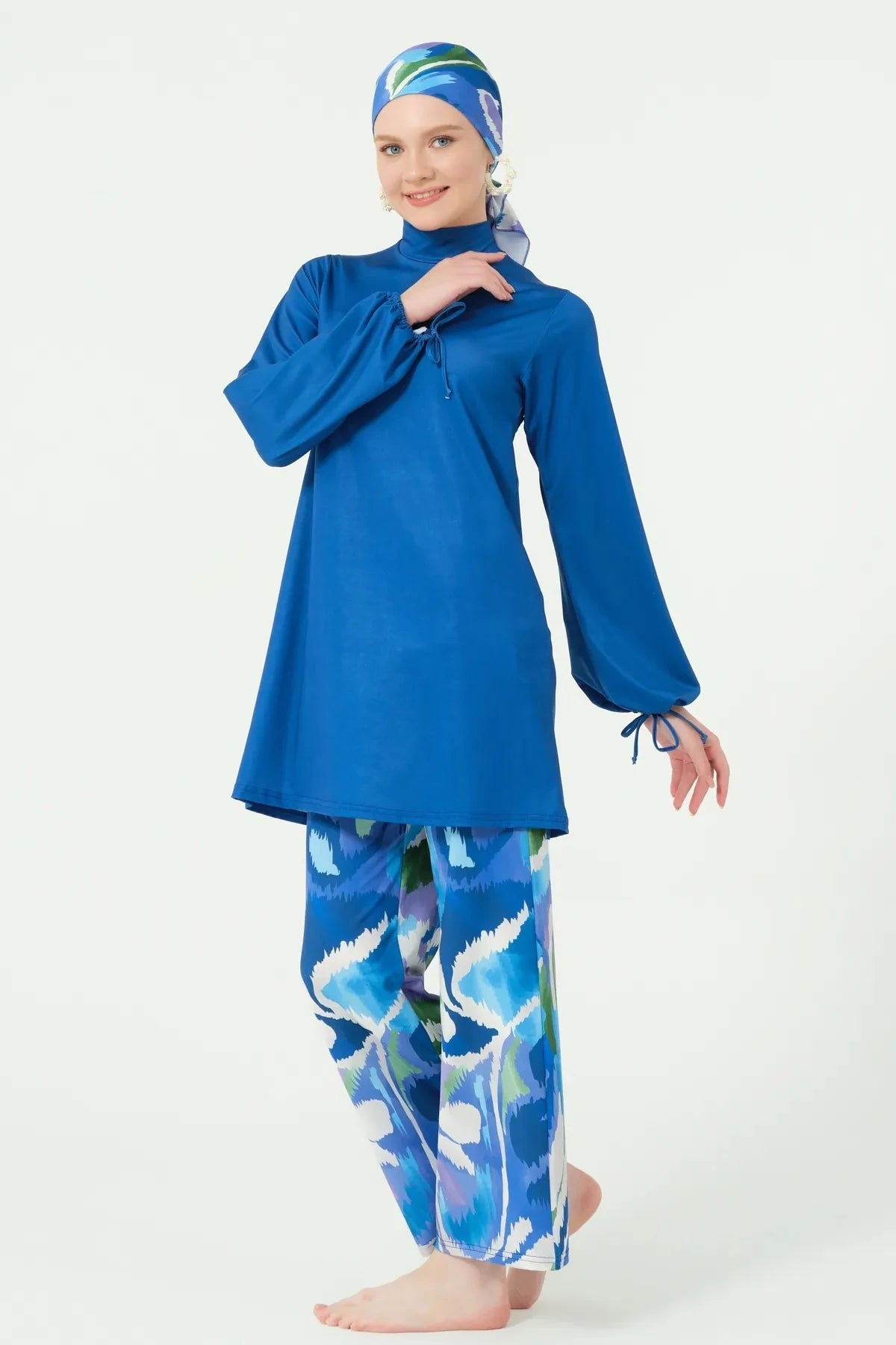 Deep azure burkini top and printed swim pants, side view.