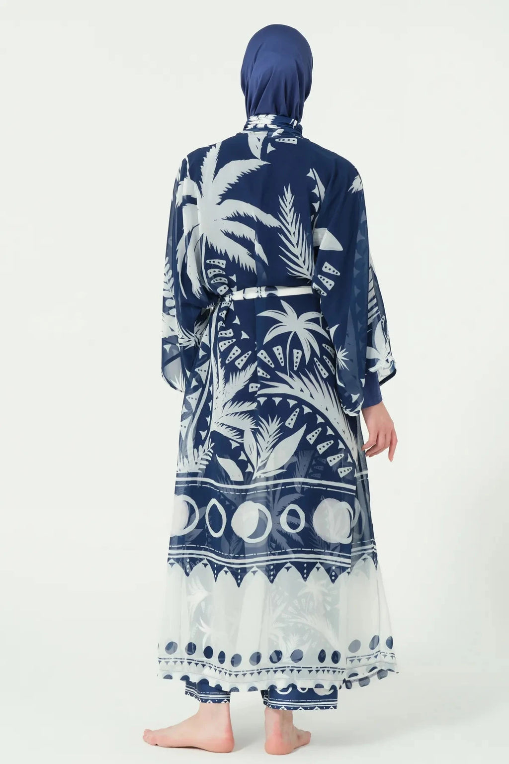 Back view of navy burkini with white palm print sheer kimono.