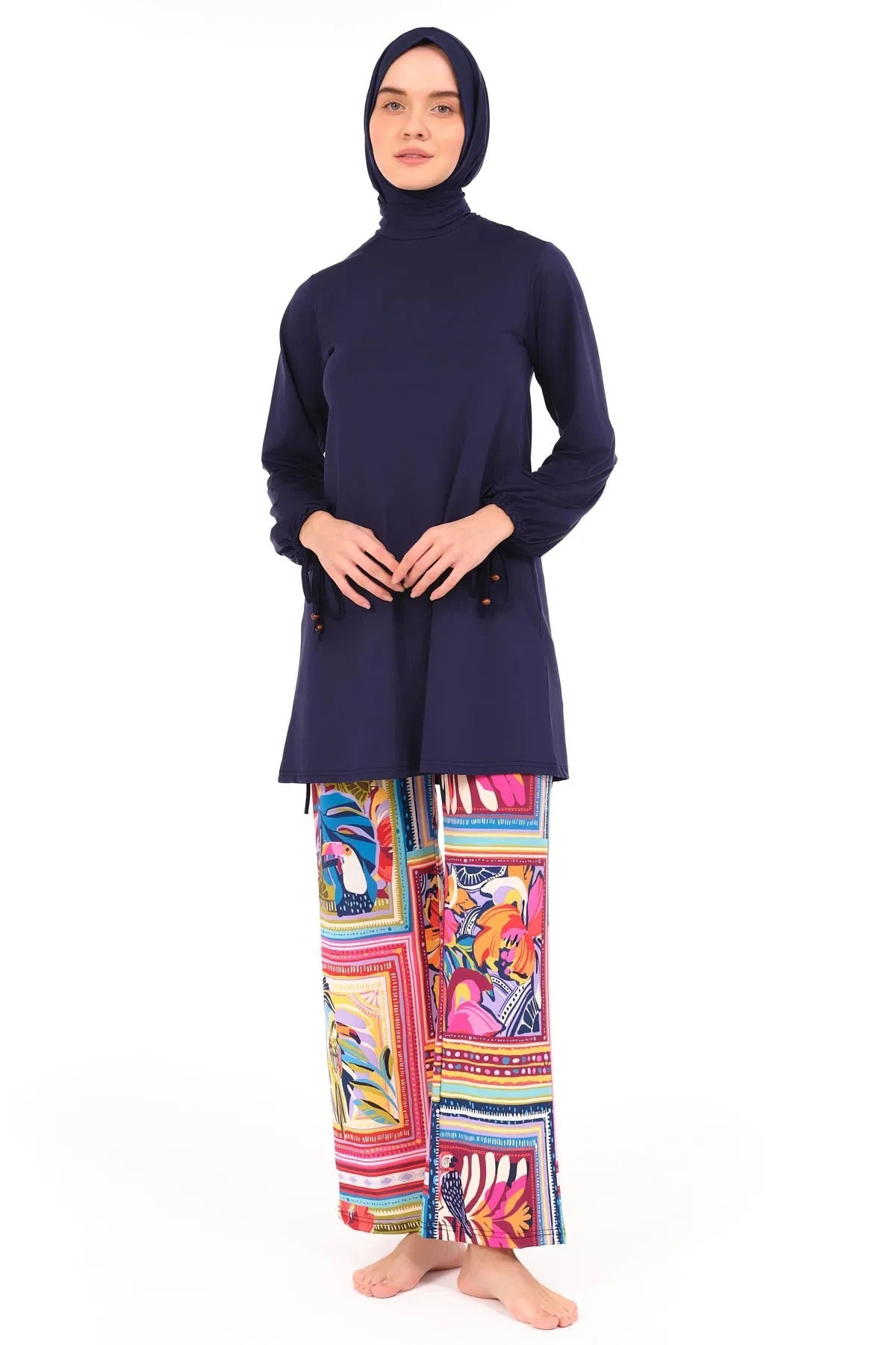 Model in navy tunic and tropical print swim pants, full front view.