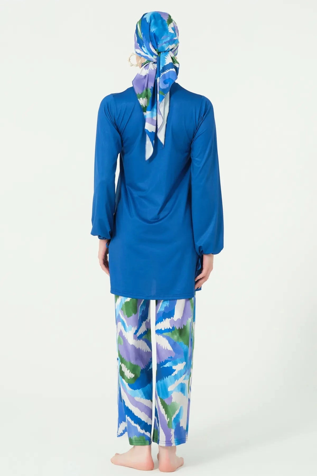 Woman in deep azure modest swimwear set, back view, full coverage.