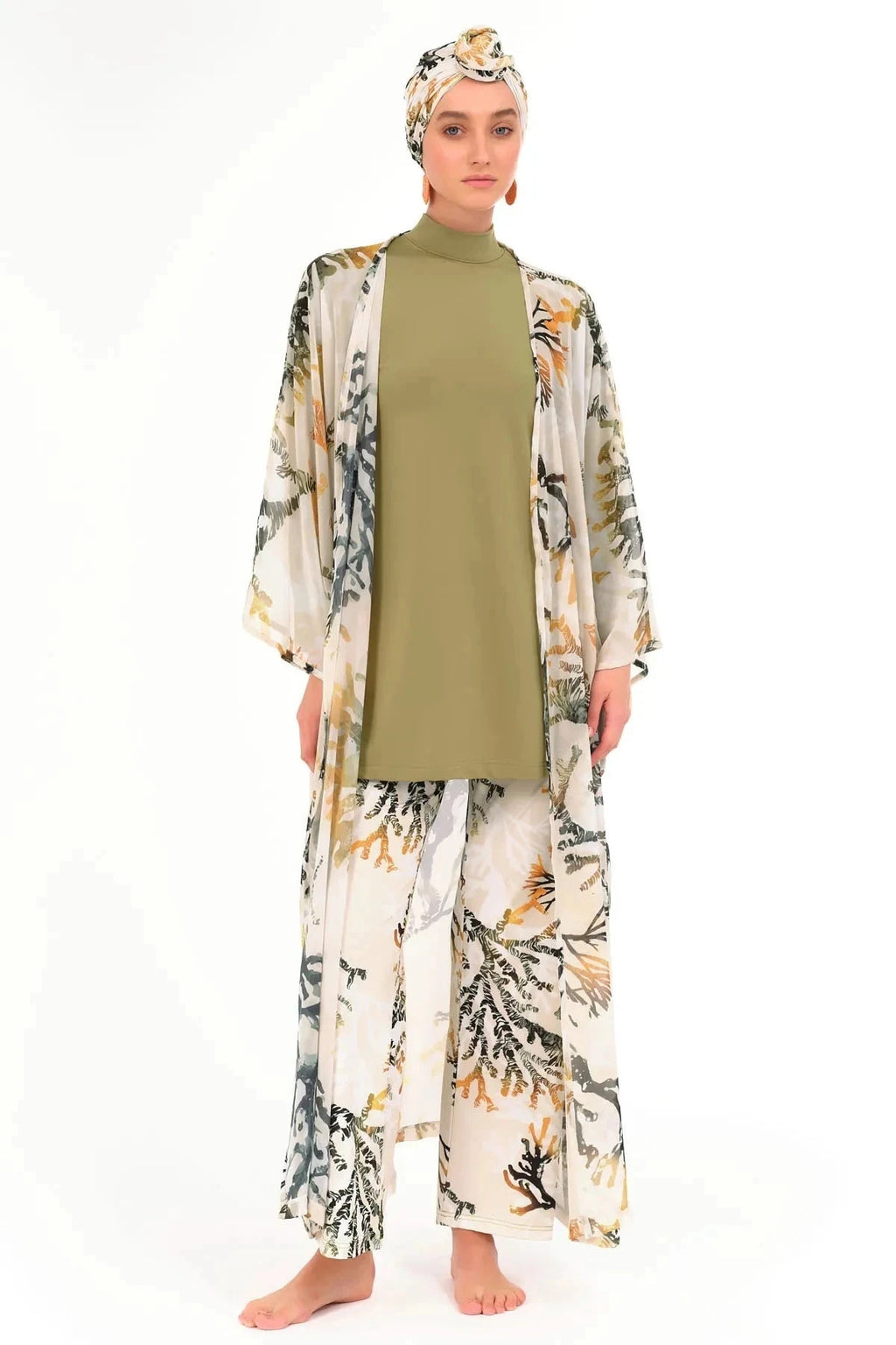 Woman in golden olive kimono, open front, showing modest swimwear underneath.