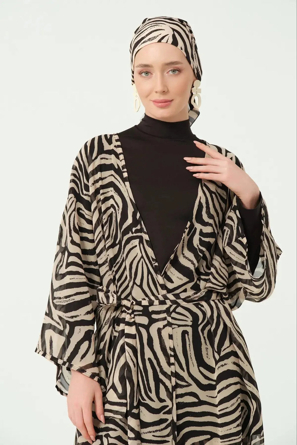Close-up of model in zebra print kimono and matching head covering.