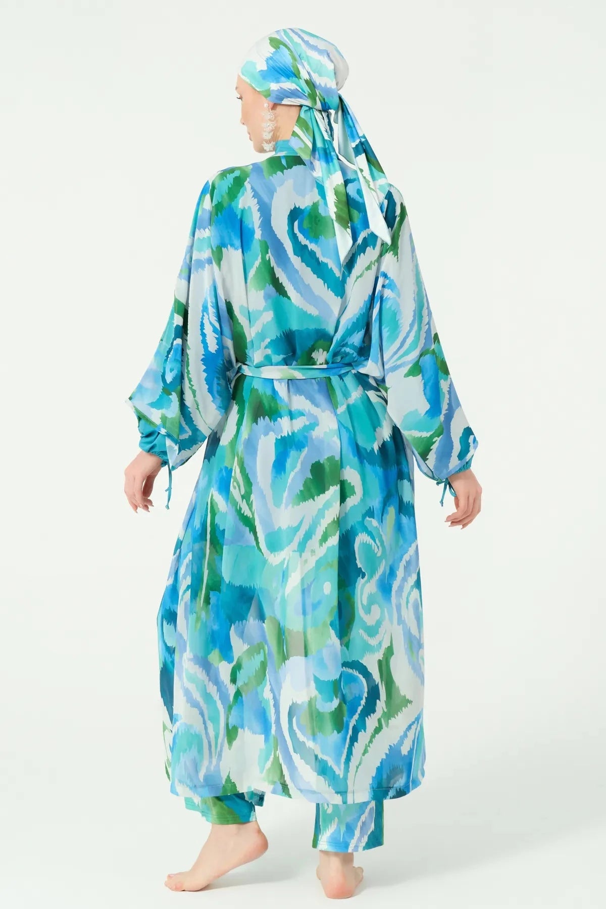 Back view of model wearing blue and green patterned modest kimono.