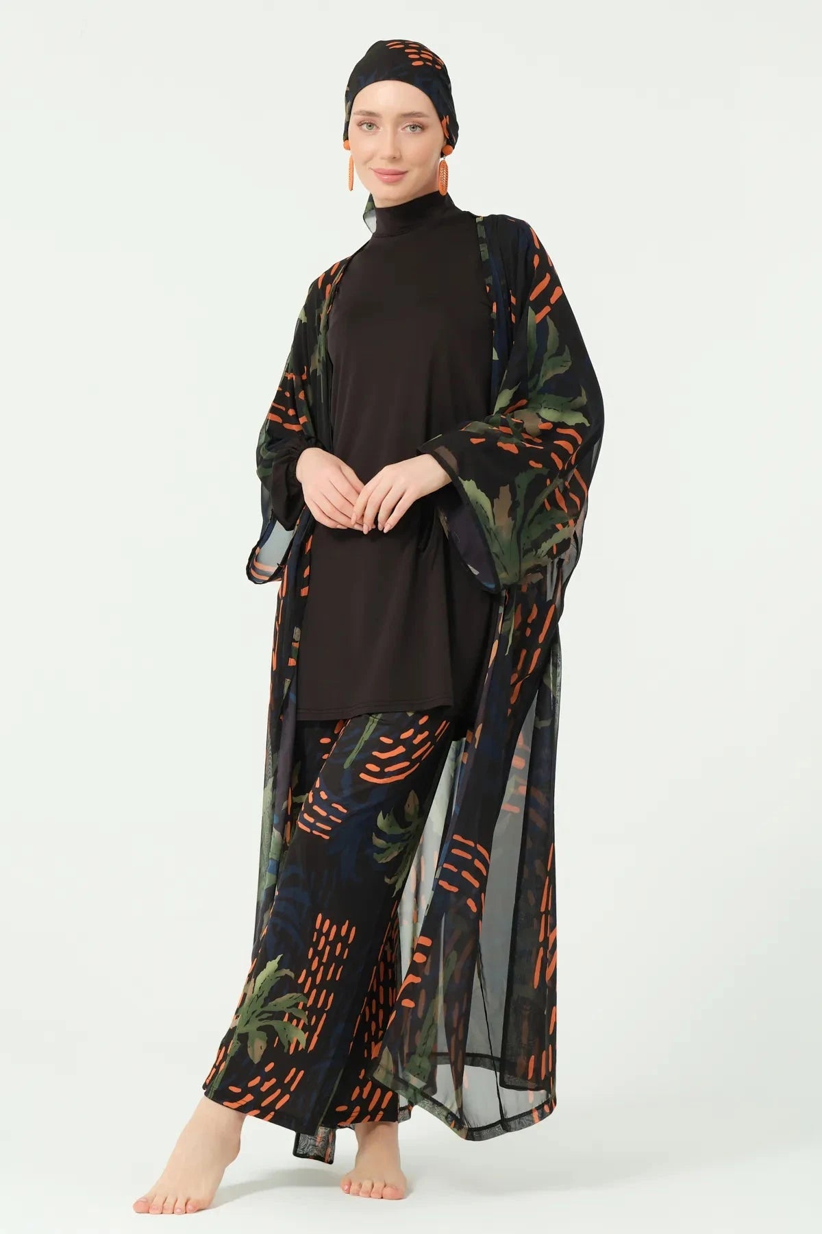 Woman in dark patterned kimono, open to show black modest swimsuit.