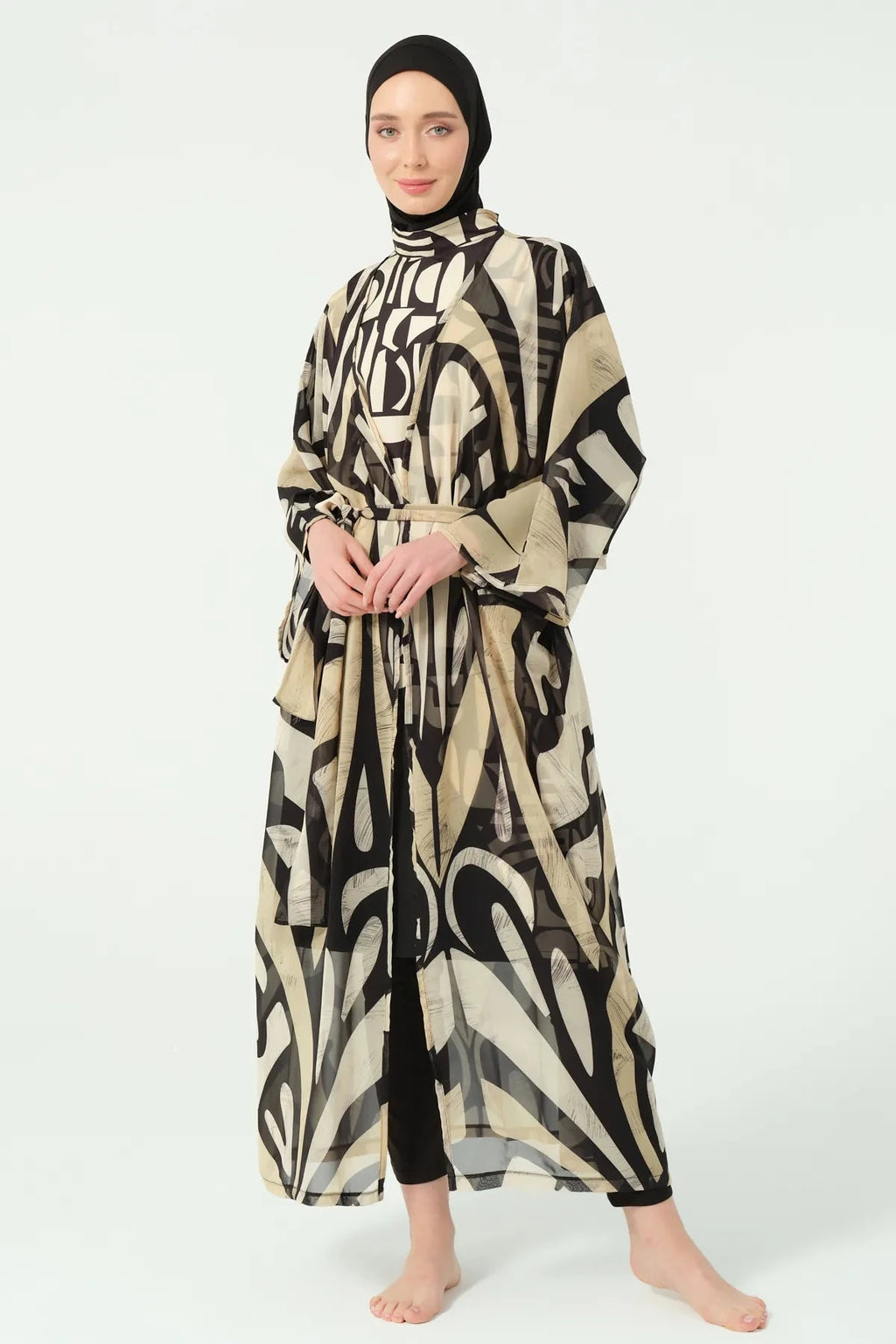 Front view of model in black and beige abstract print kimono with tie belt.