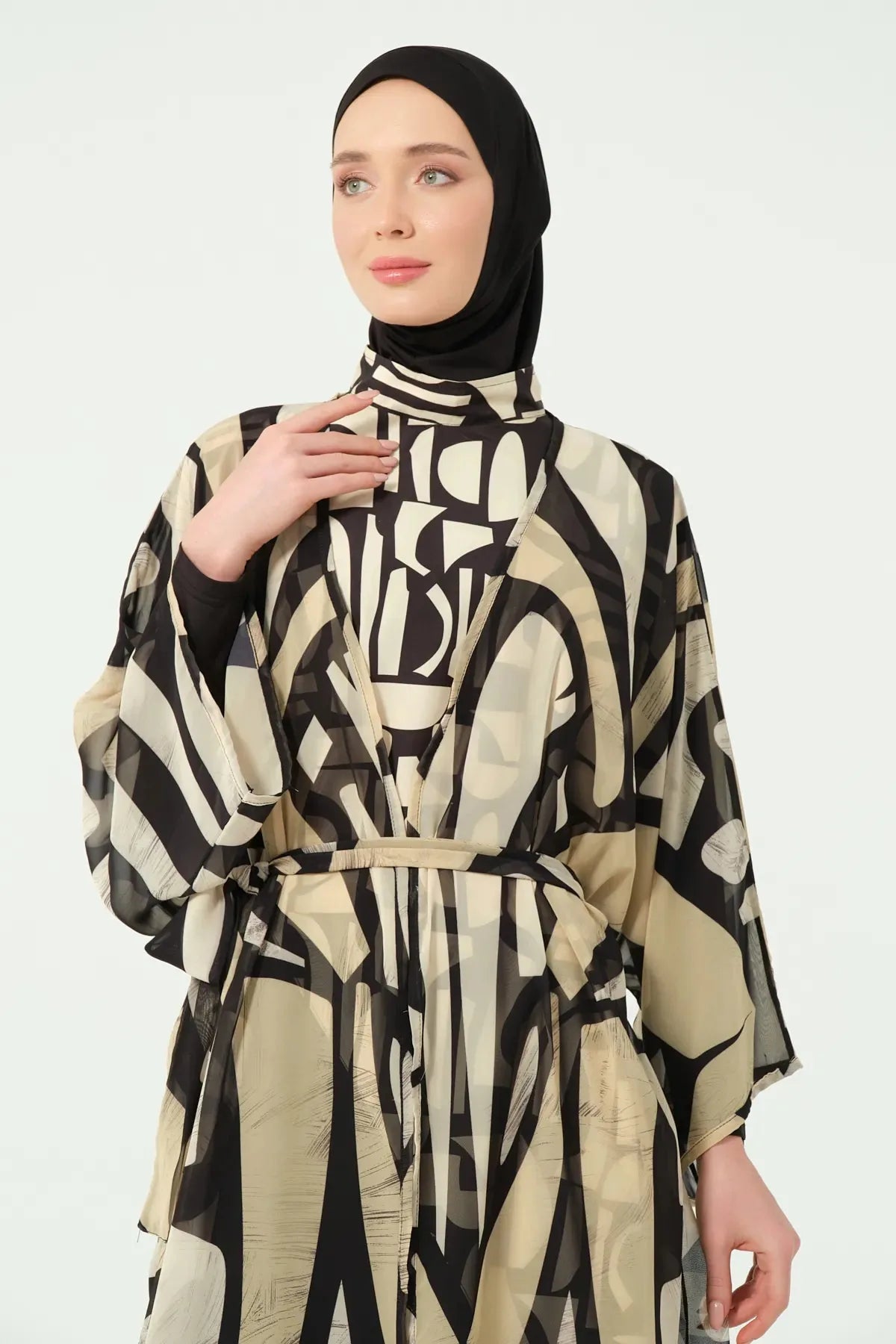 Close-up of black and beige abstract print kimono with tie belt detail.