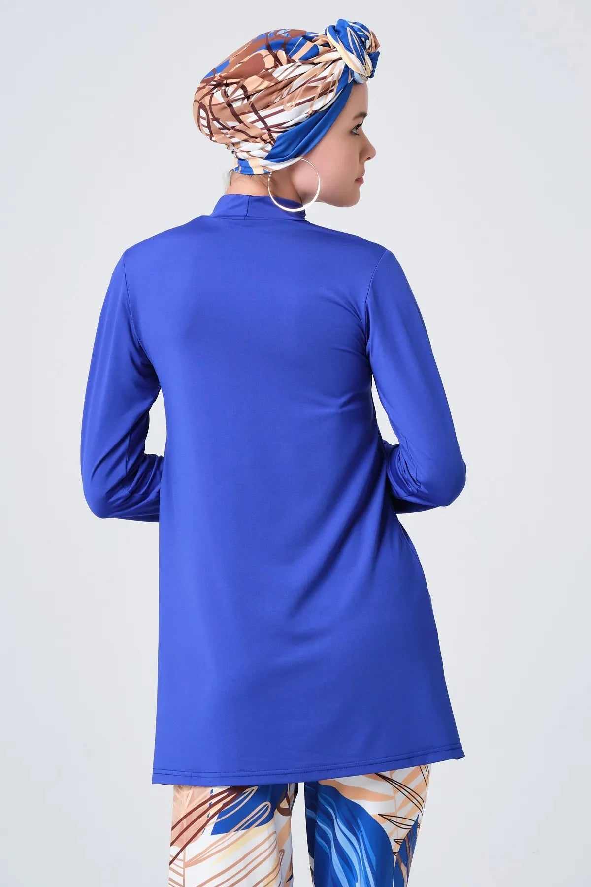 Back view close-up of sapphire blue modest tunic and printed headscarf.