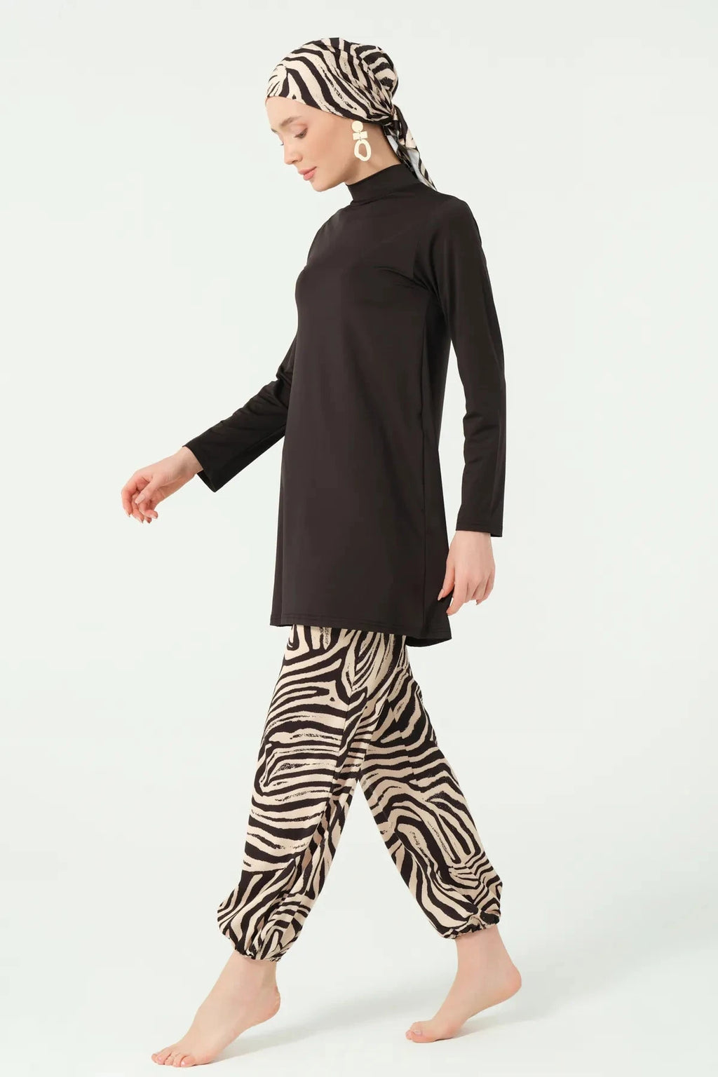 Black top and zebra print modest swim pants with matching head covering side.