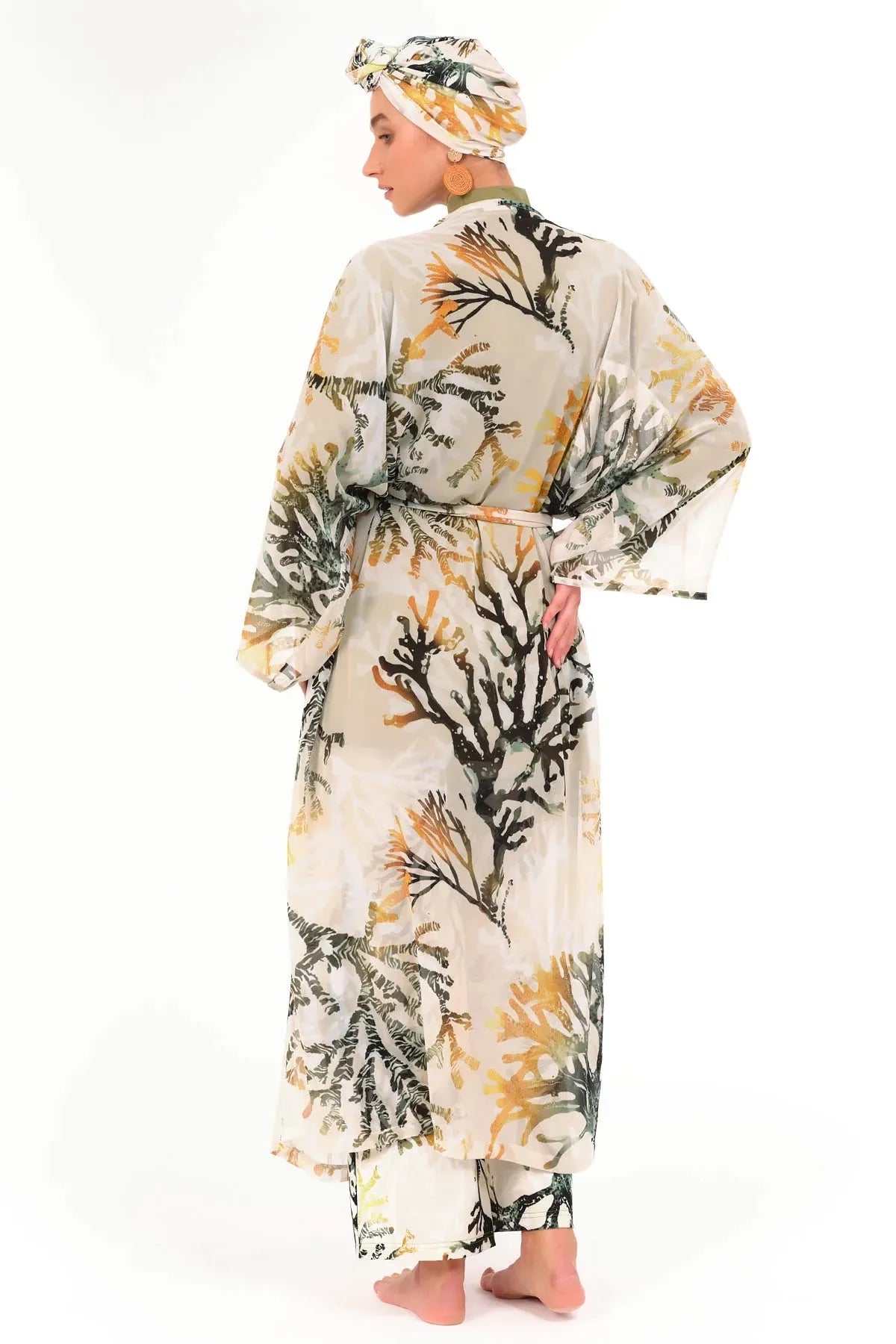 Model in printed modest swimsuit with kimono and head covering back view