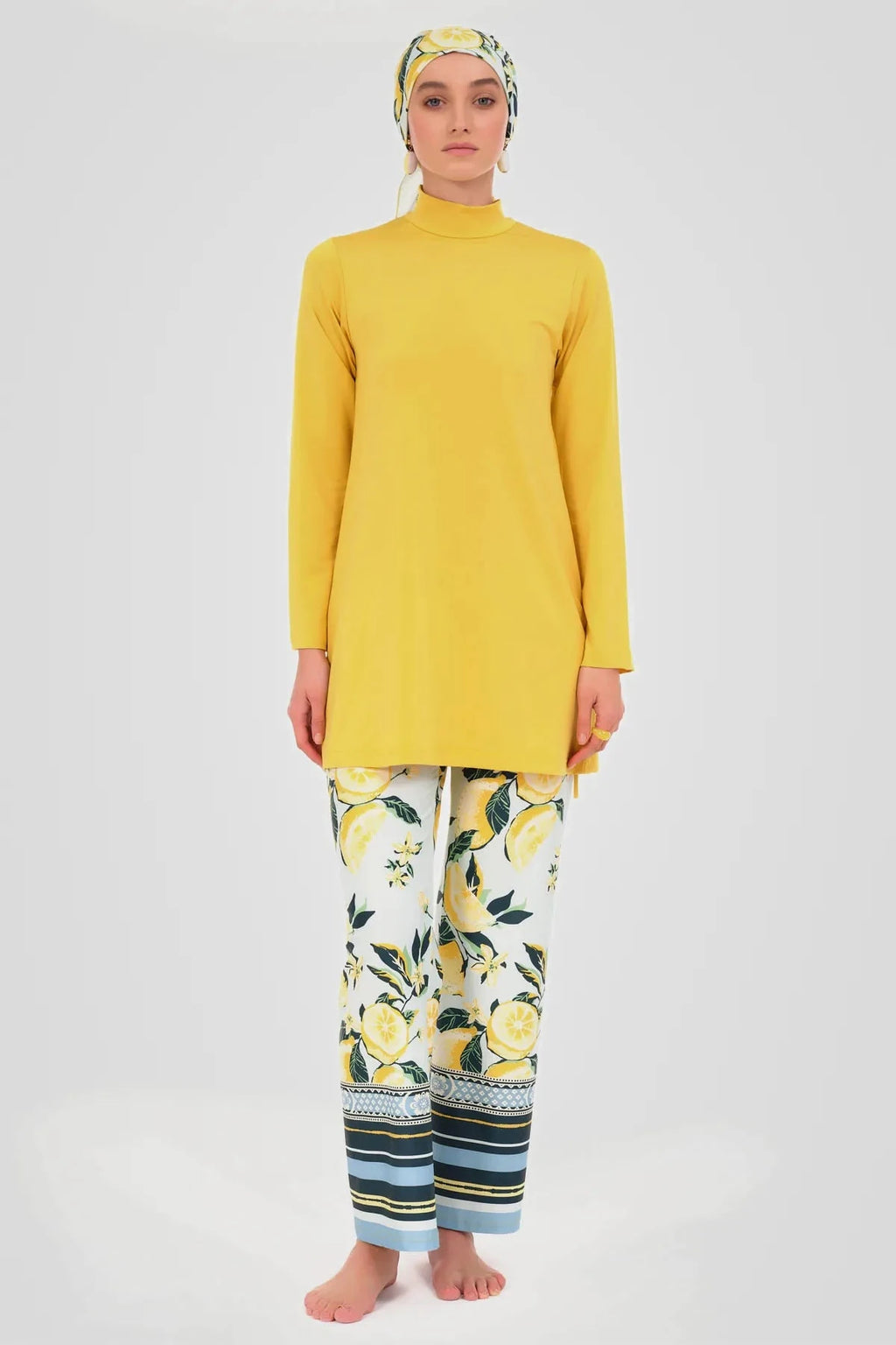 Model wearing yellow tunic, lemon print swim pants, and matching headscarf.