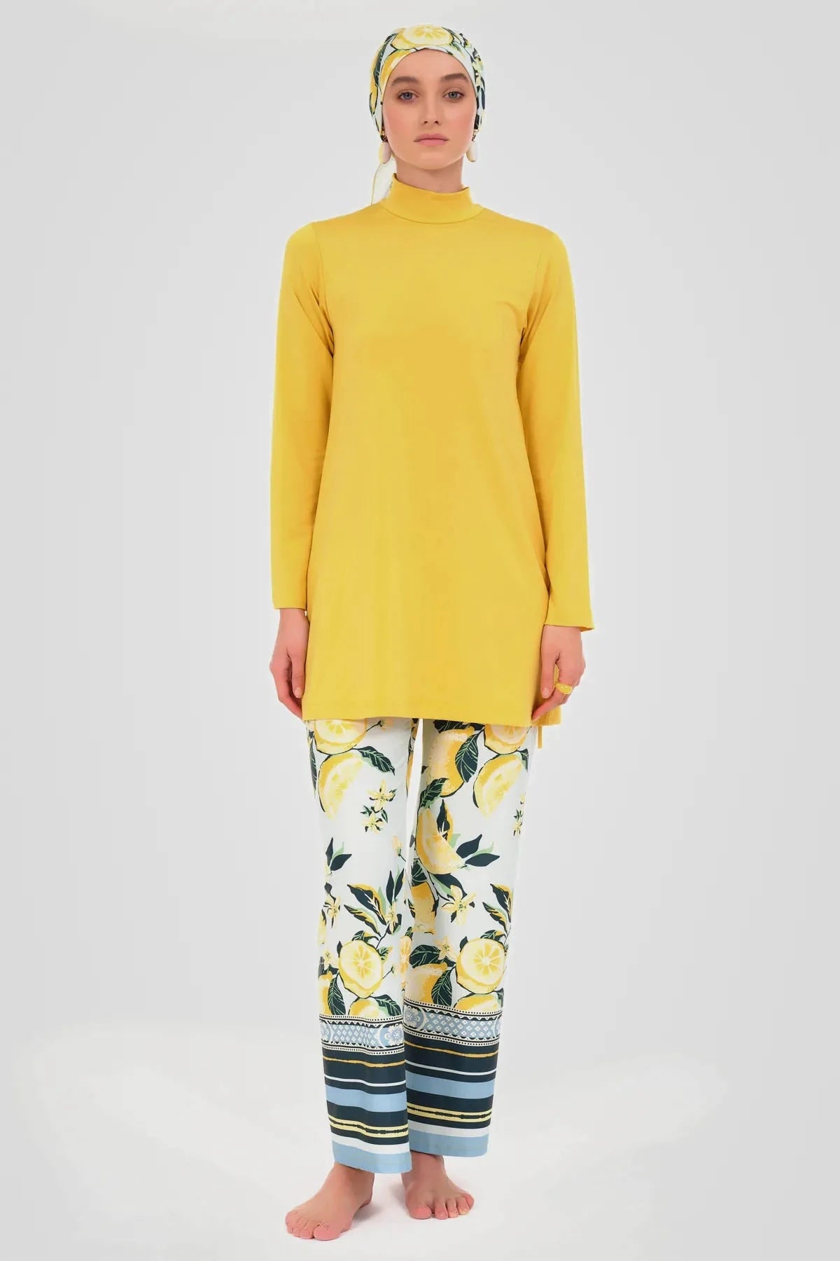 Model wearing yellow tunic, lemon print swim pants, and matching headscarf.