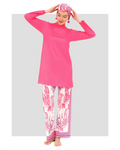 Model in fuchsia modest swimwear set with tropical print pants, front pose.