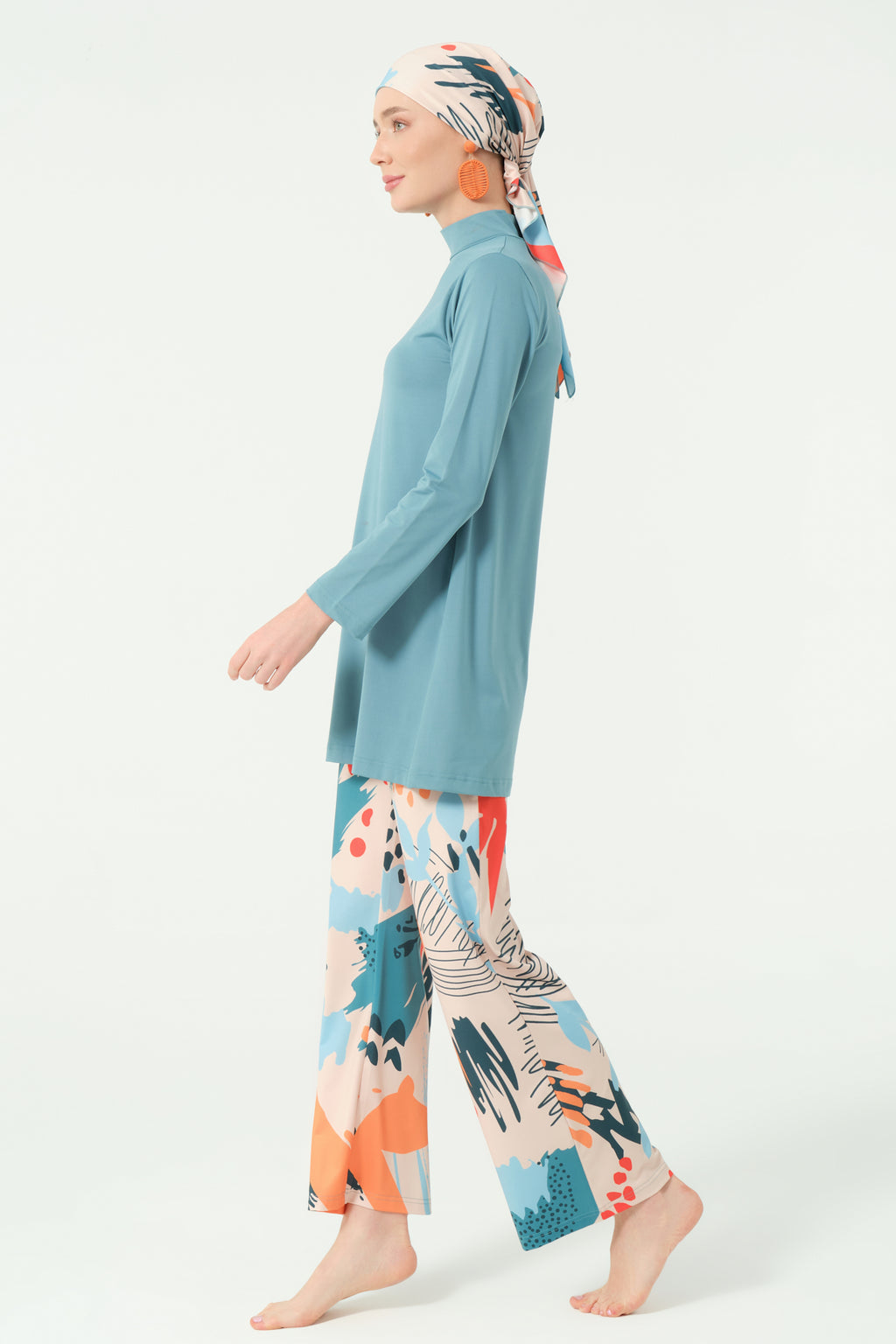 Modest swimwear set in persian green and abstract print, side profile.