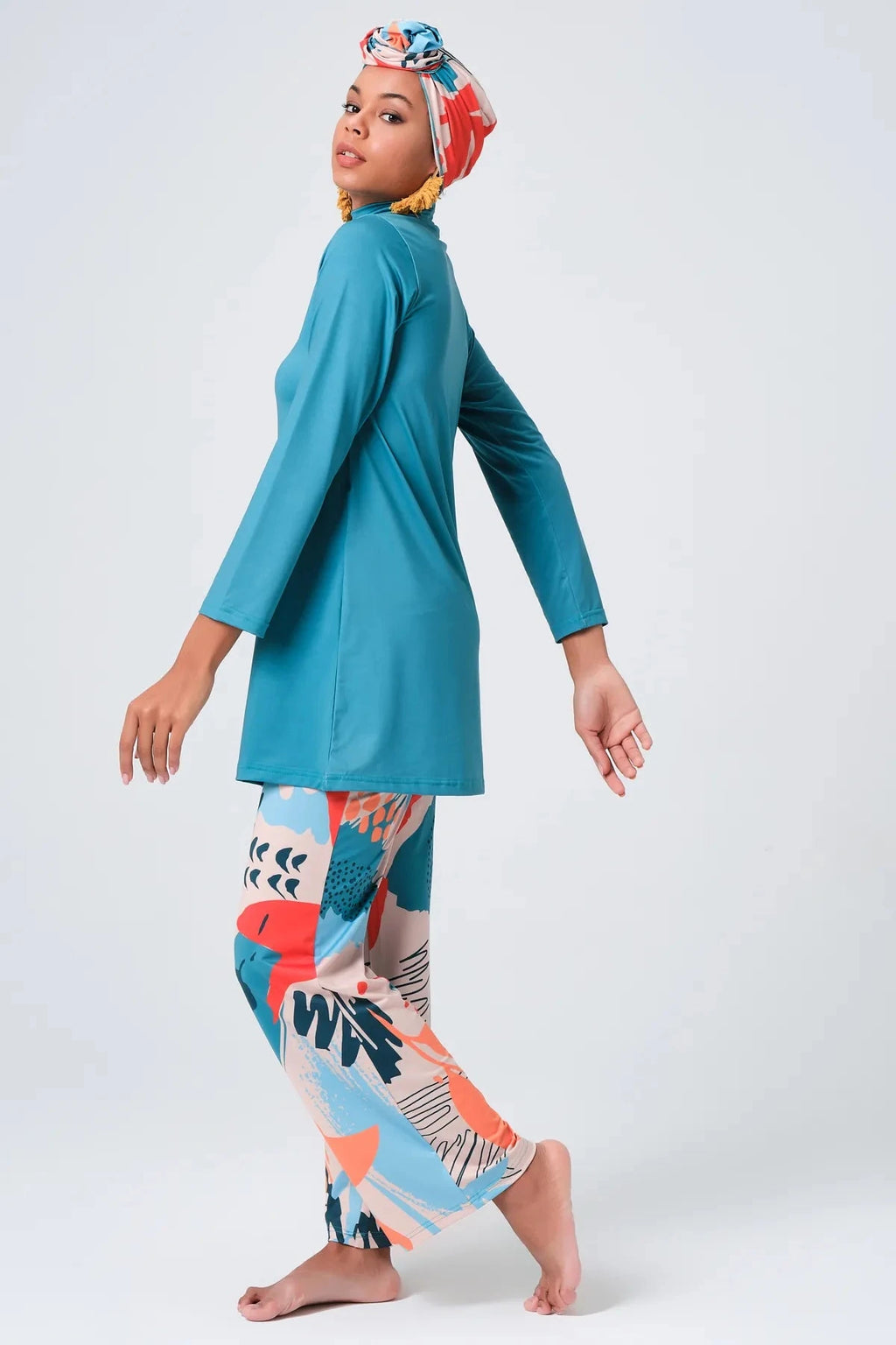 Modest swimwear set in persian green and abstract print, side profile.