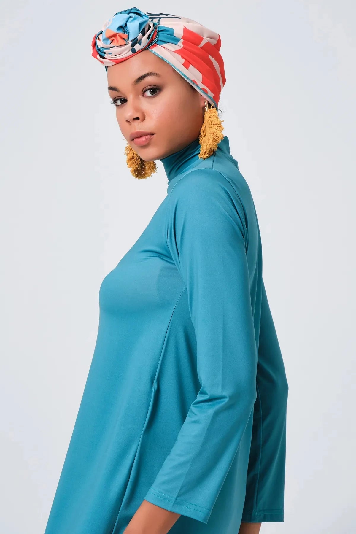 Close-up of persian green modest swimwear tunic and printed headscarf.