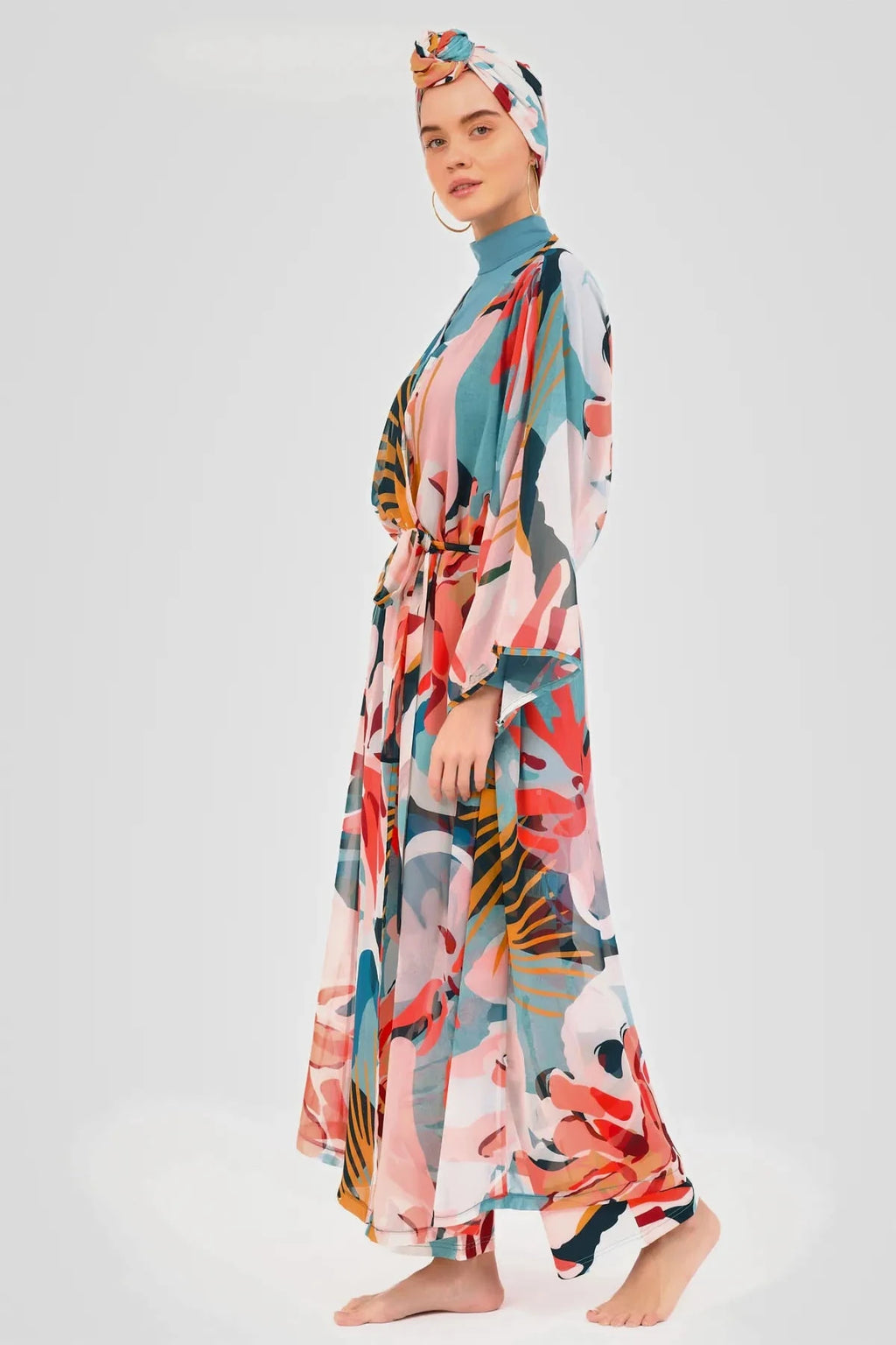 Model wearing vibrant floral print sheer kimono with tie belt, side view.